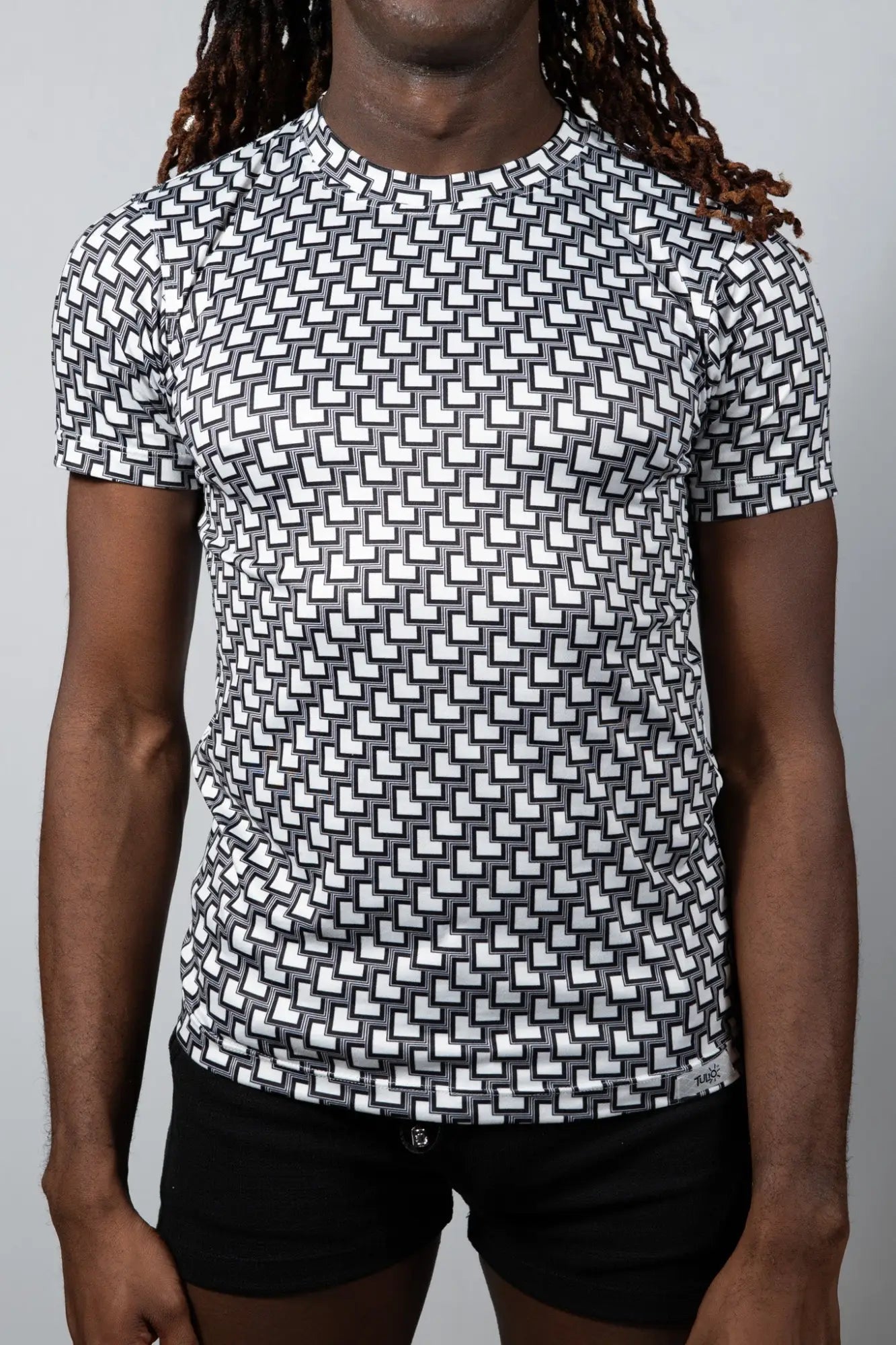 Black and white geometric patterned short sleeve rash guard tile print tee for sun protection and active wear