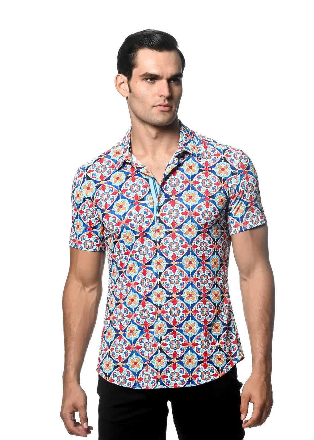 A man wearing a tile printed performance short sleeve shirt with a vibrant blue red and white geometric pattern and contrast placket