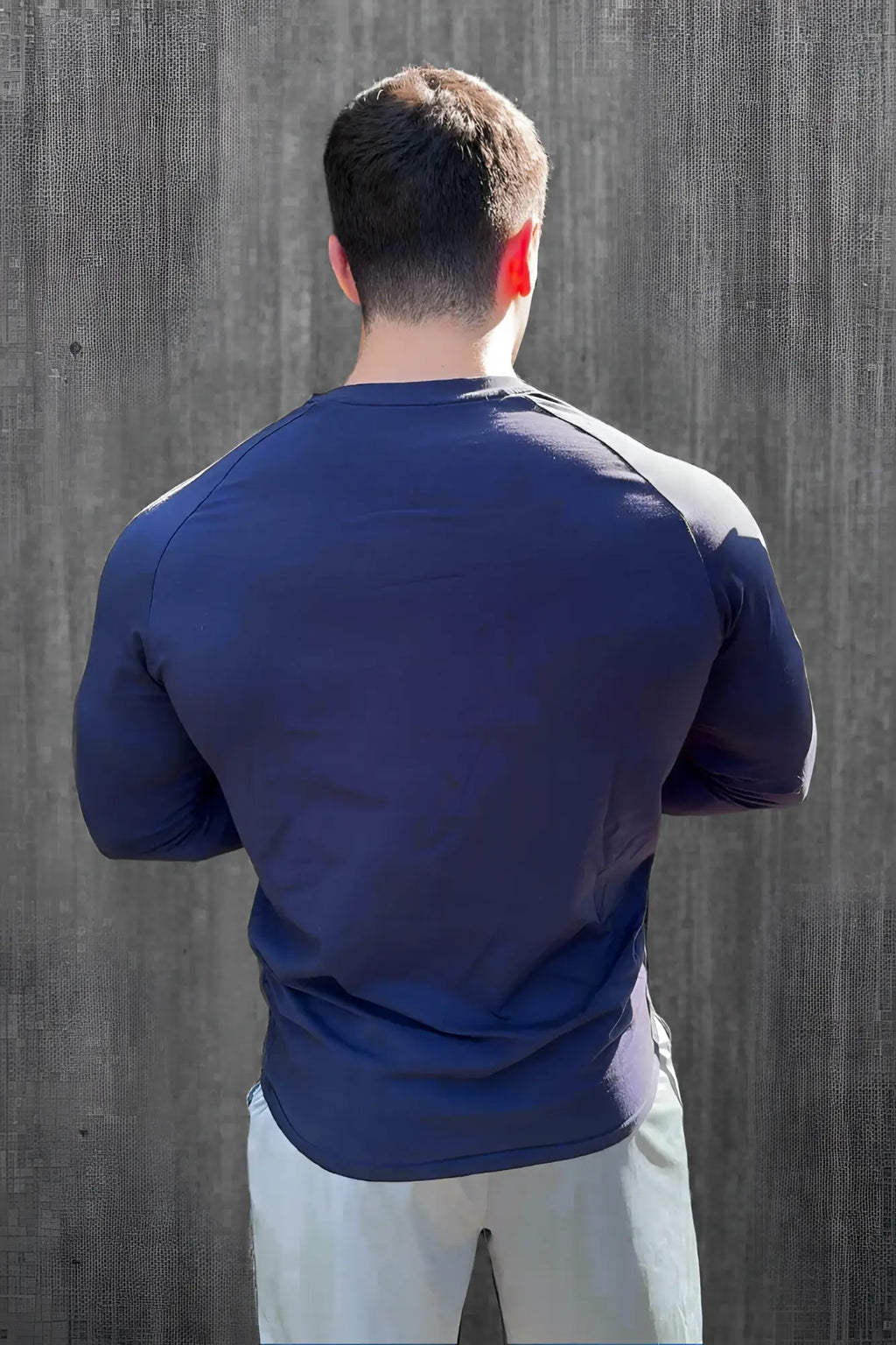 Navy muscle-fit long sleeve athletic shirt with gray shoulder panels designed for performance and comfort