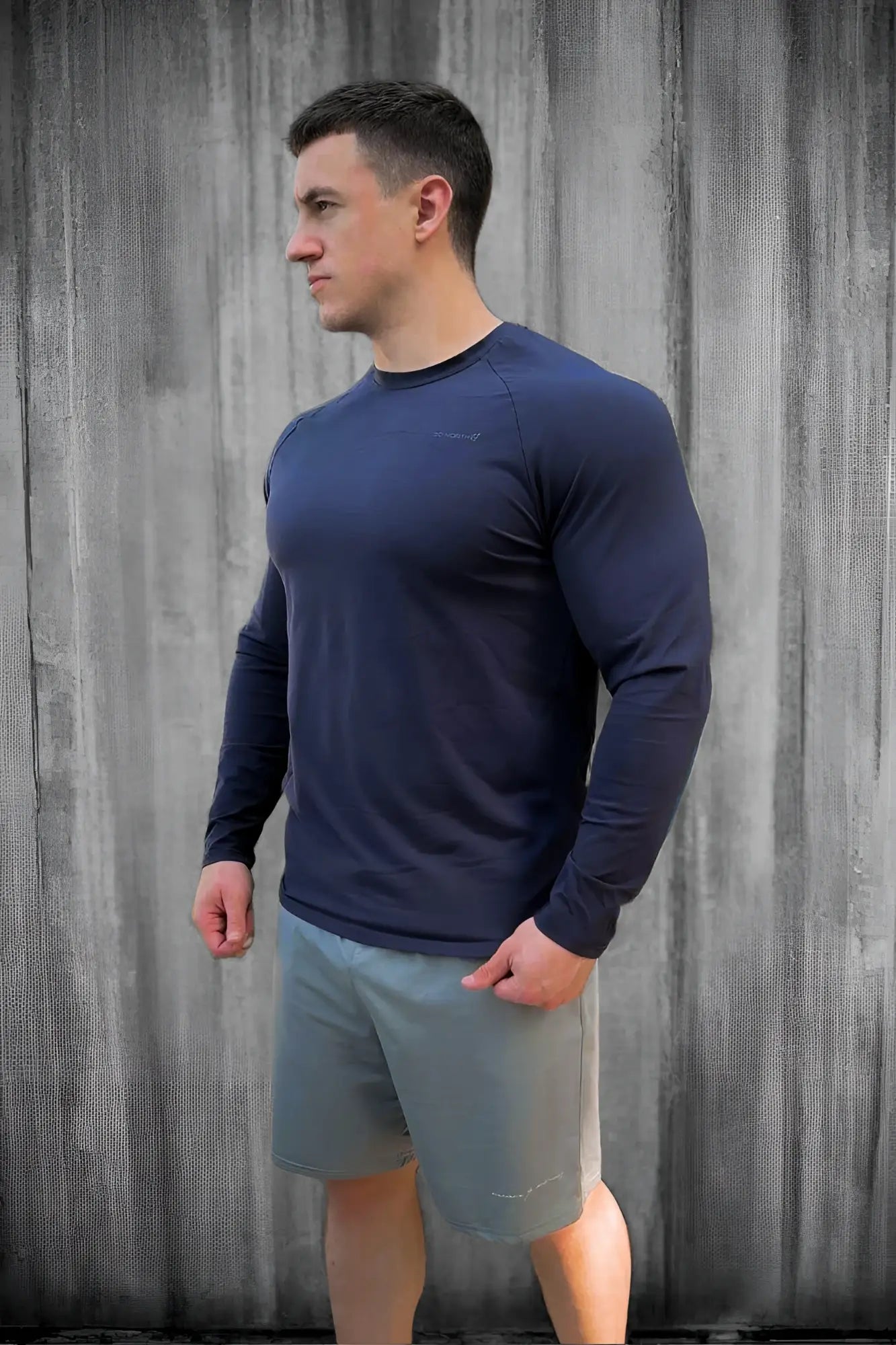 Navy titan muscle-fit long sleeve athletic shirt with crew neck and subtle seam detailing for performance wear