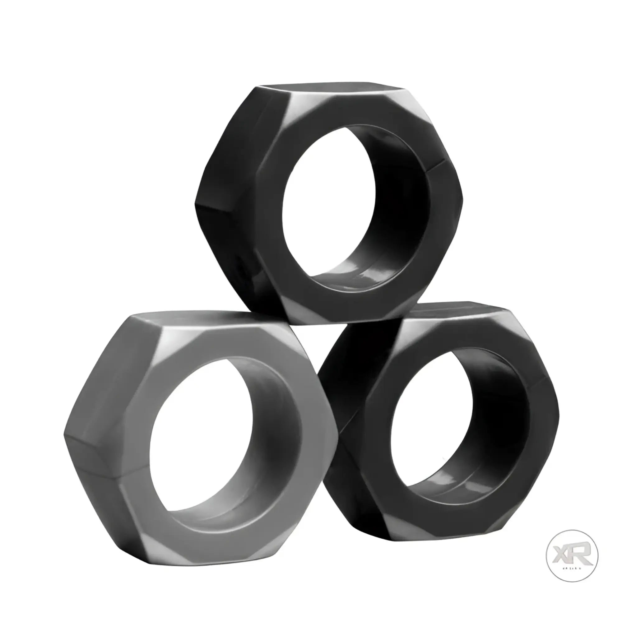 Three black, hexagonal Tom of Finland Cock Nuts stacked in a pyramid shape against a plain white background.