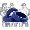 Tom of Finland 3-piece blue silicone cock ring set featuring embossed logos, displayed over illustrative figure art.