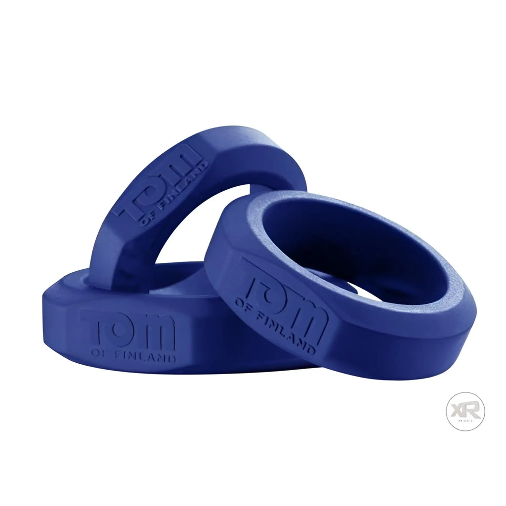 Three blue, silicone Tom of Finland cock rings embossed with the brand logo, arranged in a stack against a white background.