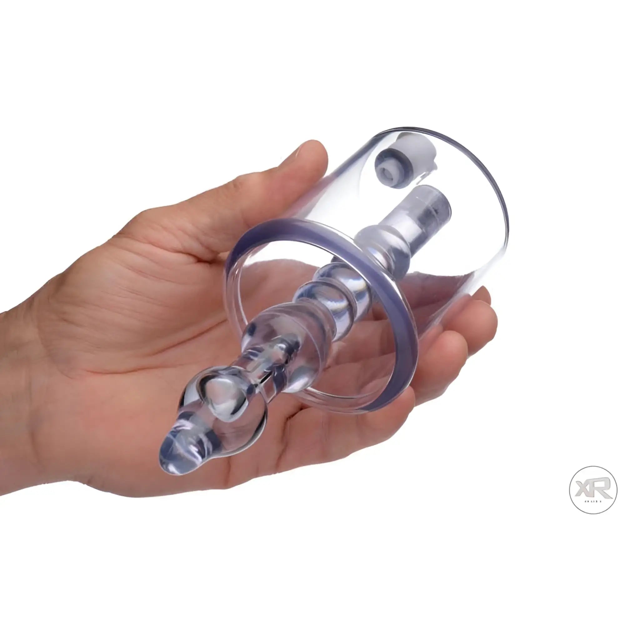 Tom of Finland clear anal pump cylinder with a ribbed internal stimulator shaft, held in a hand.
