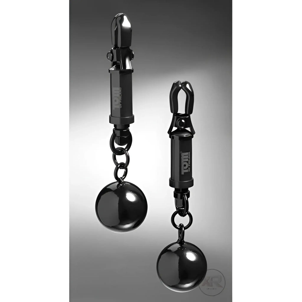 Black metallic ball-shaped nipple clamps with polished finish and troll engraving from tom of finland barrel series