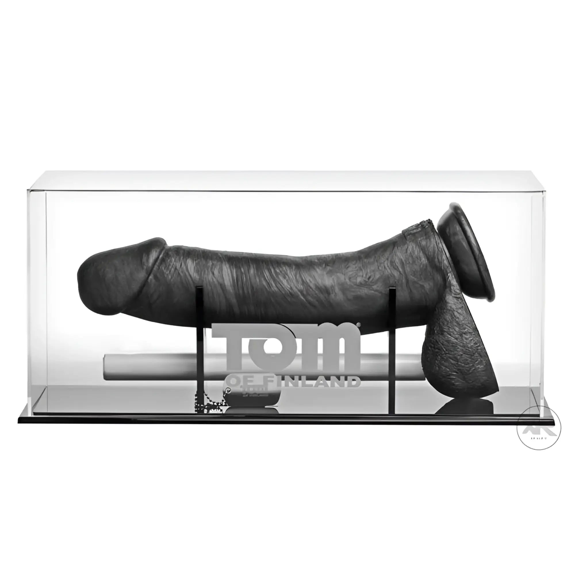 A 12-inch black textured Tom of Finland Kake Cock silicone dildo displayed horizontally in a clear acrylic case.