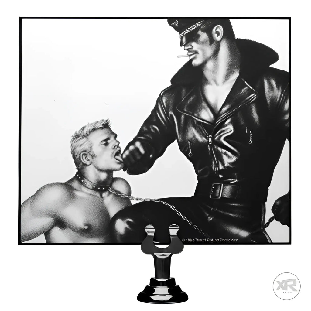 Black and white Tom of Finland Leash print showing a leather-clad man holding a leash connected to a collar.
