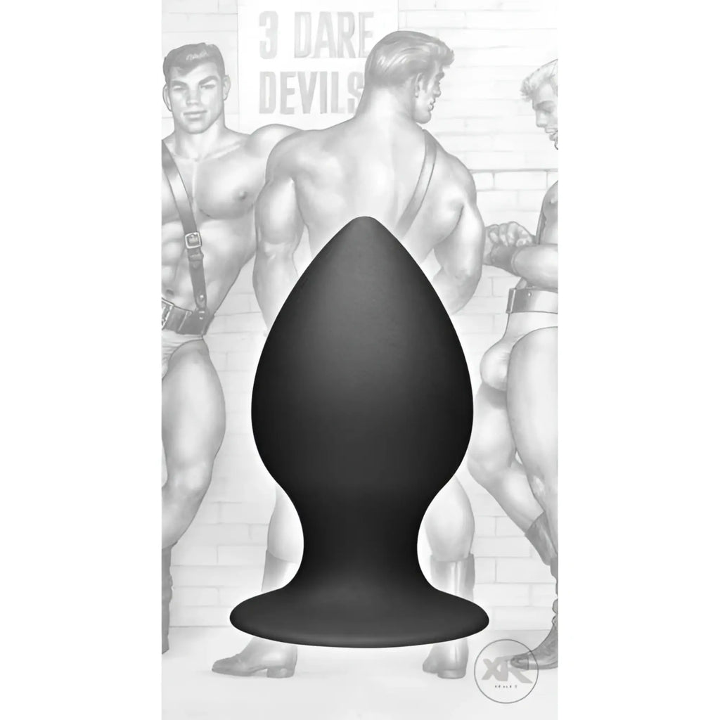 Tom of Finland medium black silicone anal plug with a tapered shape and wide base against a vintage illustration backdrop.