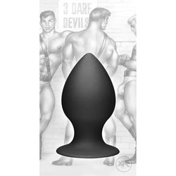 Tom of Finland medium black silicone anal plug with a tapered shape and wide base against a vintage illustration backdrop.