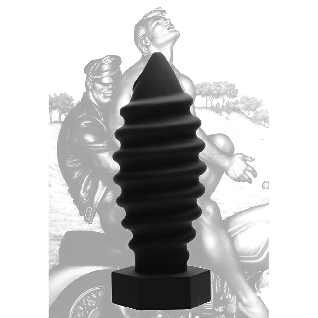 Tom of Finland Screw U anal plug: A black, spiraled, tapered silicone plug with a hexagonal base over a biker image.