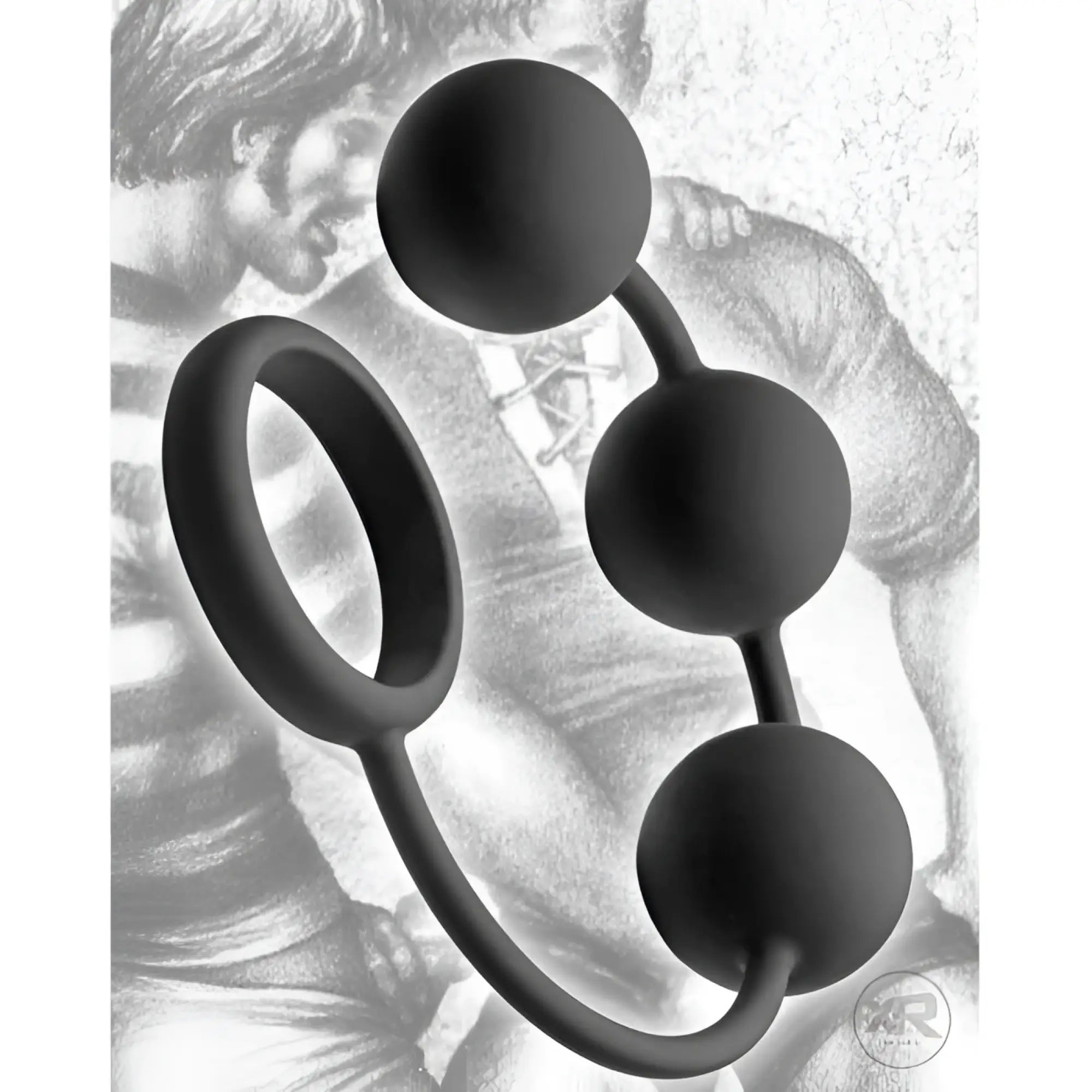 Tom of Finland matte black silicone cock ring with three weighted anal balls, set against a sketched illustration background.