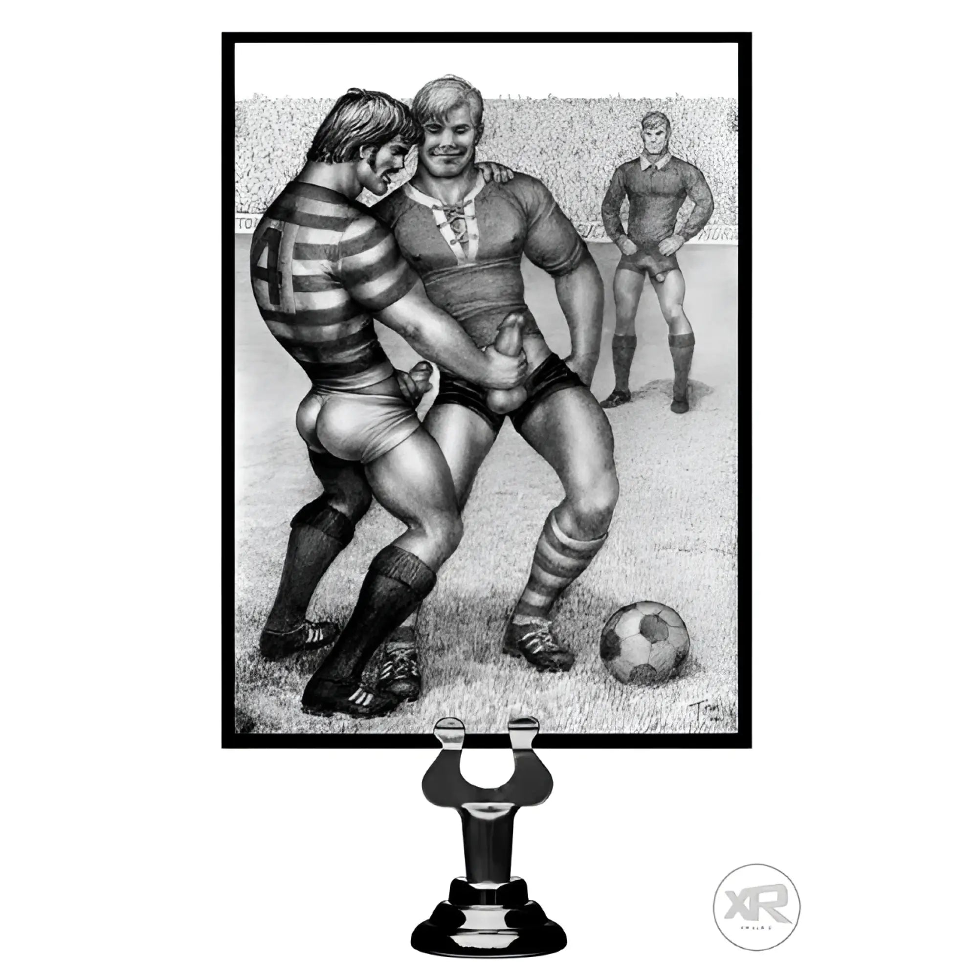 Tom of Finland silicone cock ring and weighted anal balls, black, presented in front of a classic erotic art print.
