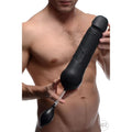 Tom of Finland Toms inflatable black silicone dildo held by a man, featuring a manual inflation pump.
