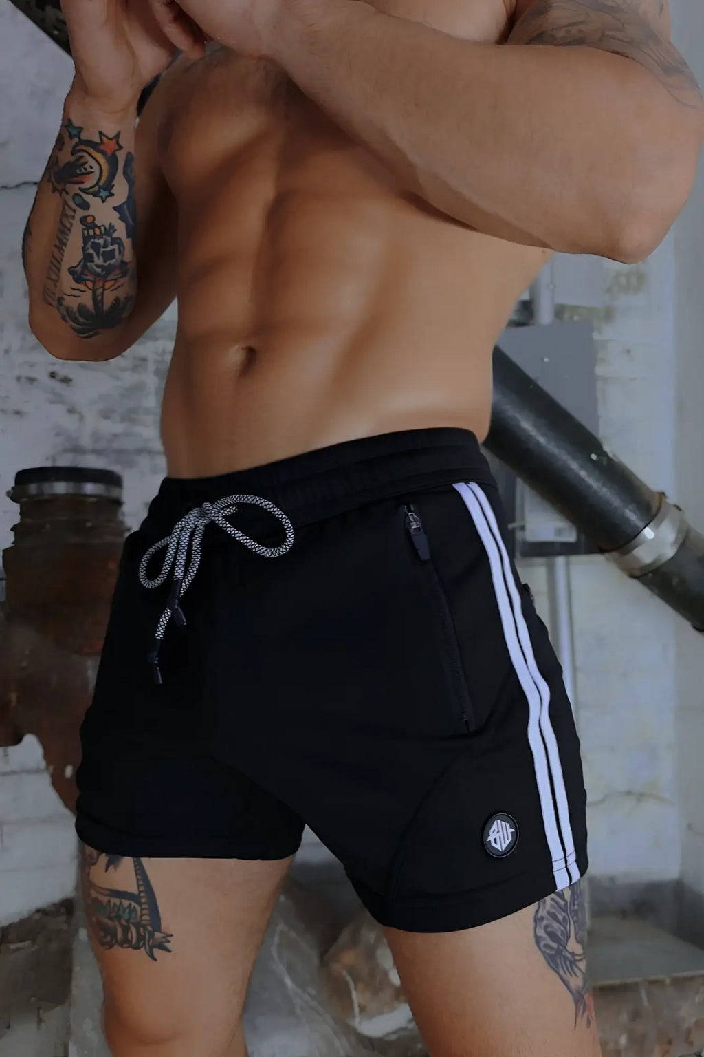 Black trade trainer shorts with white side stripes and matching drawstring waistband for athletic use