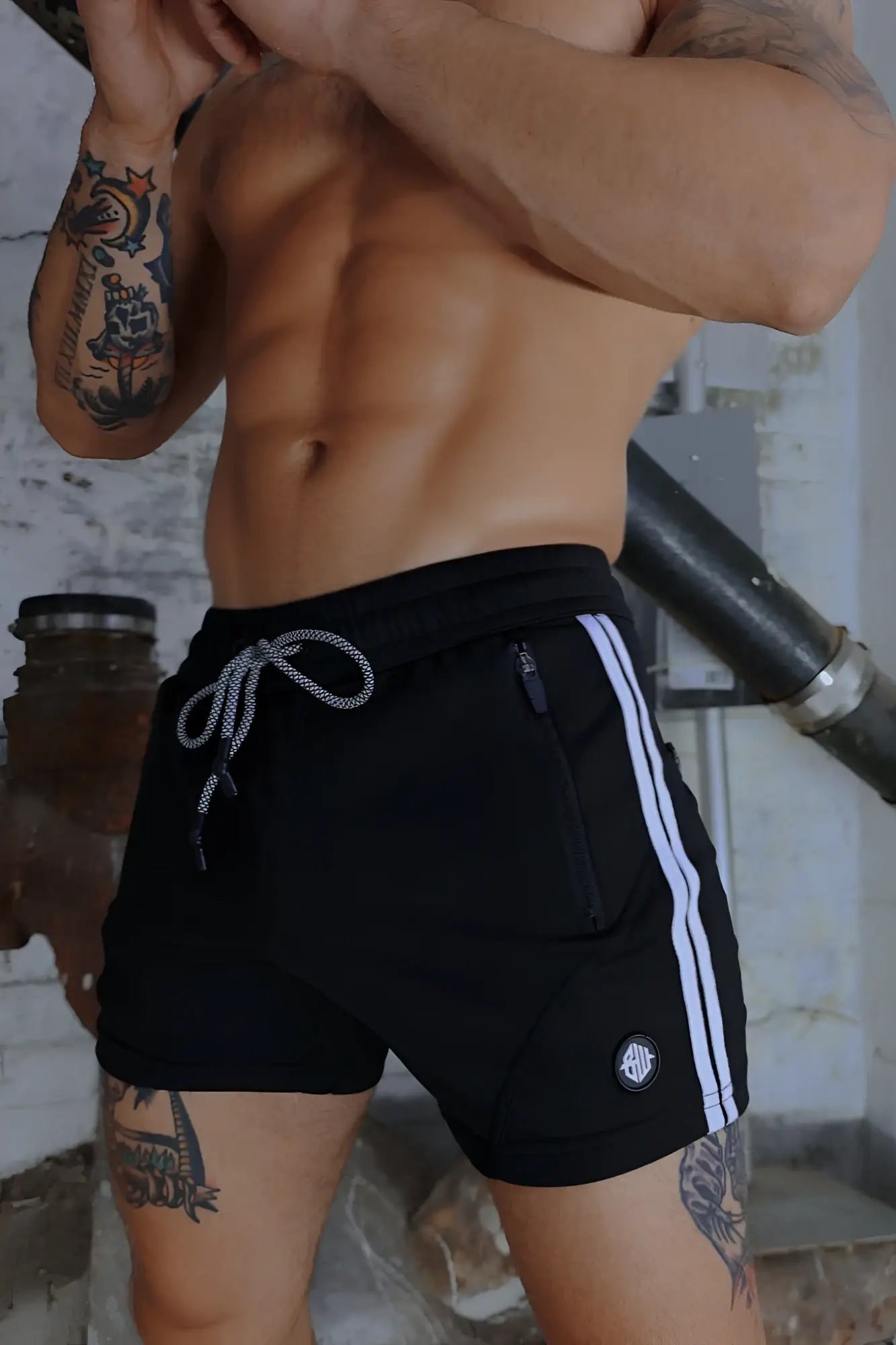 Black trade trainer shorts with white side stripes and matching drawstring waistband for athletic use