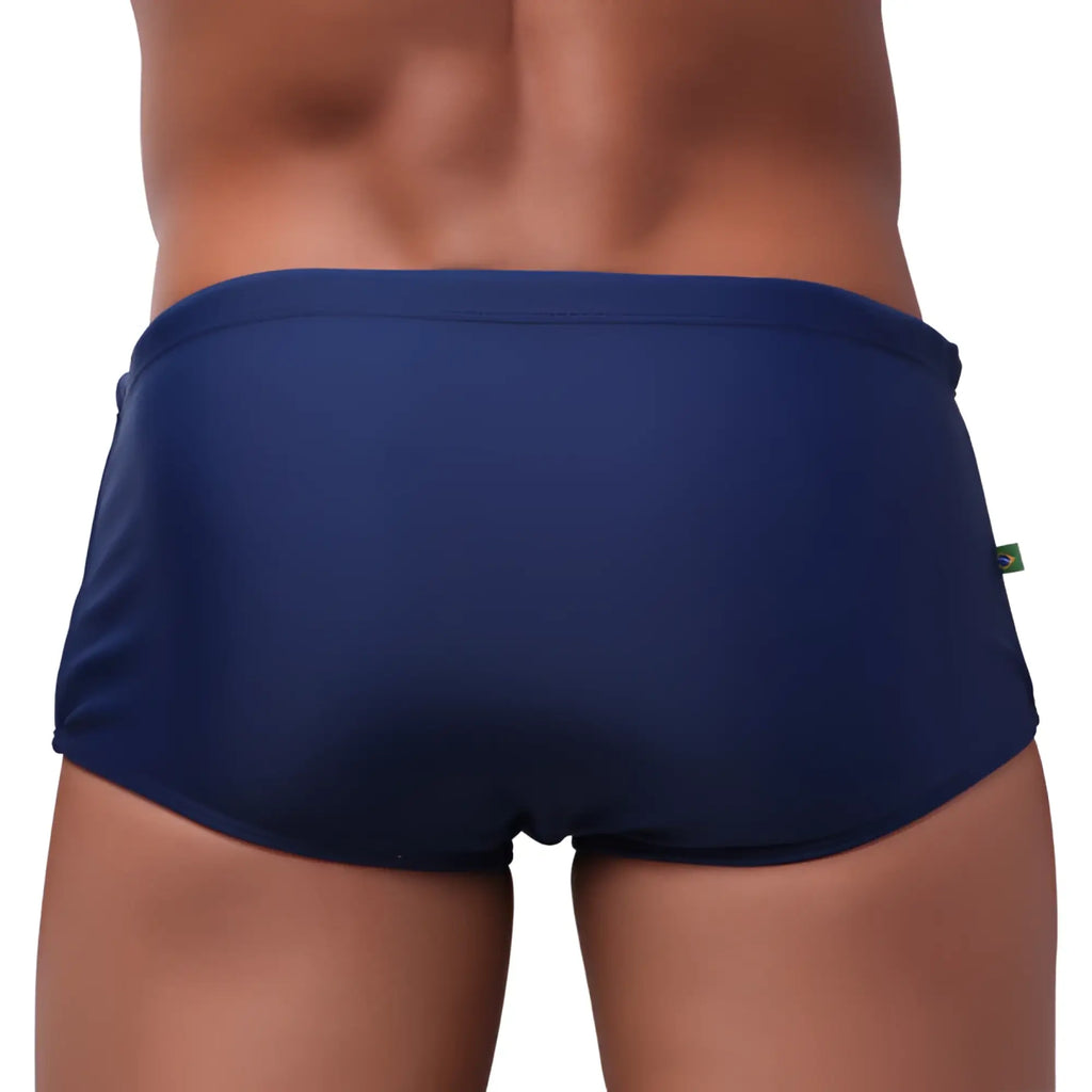 Navy blue traditional square solids cut sunga swim trunks with green and yellow flag tag on side seam for men
