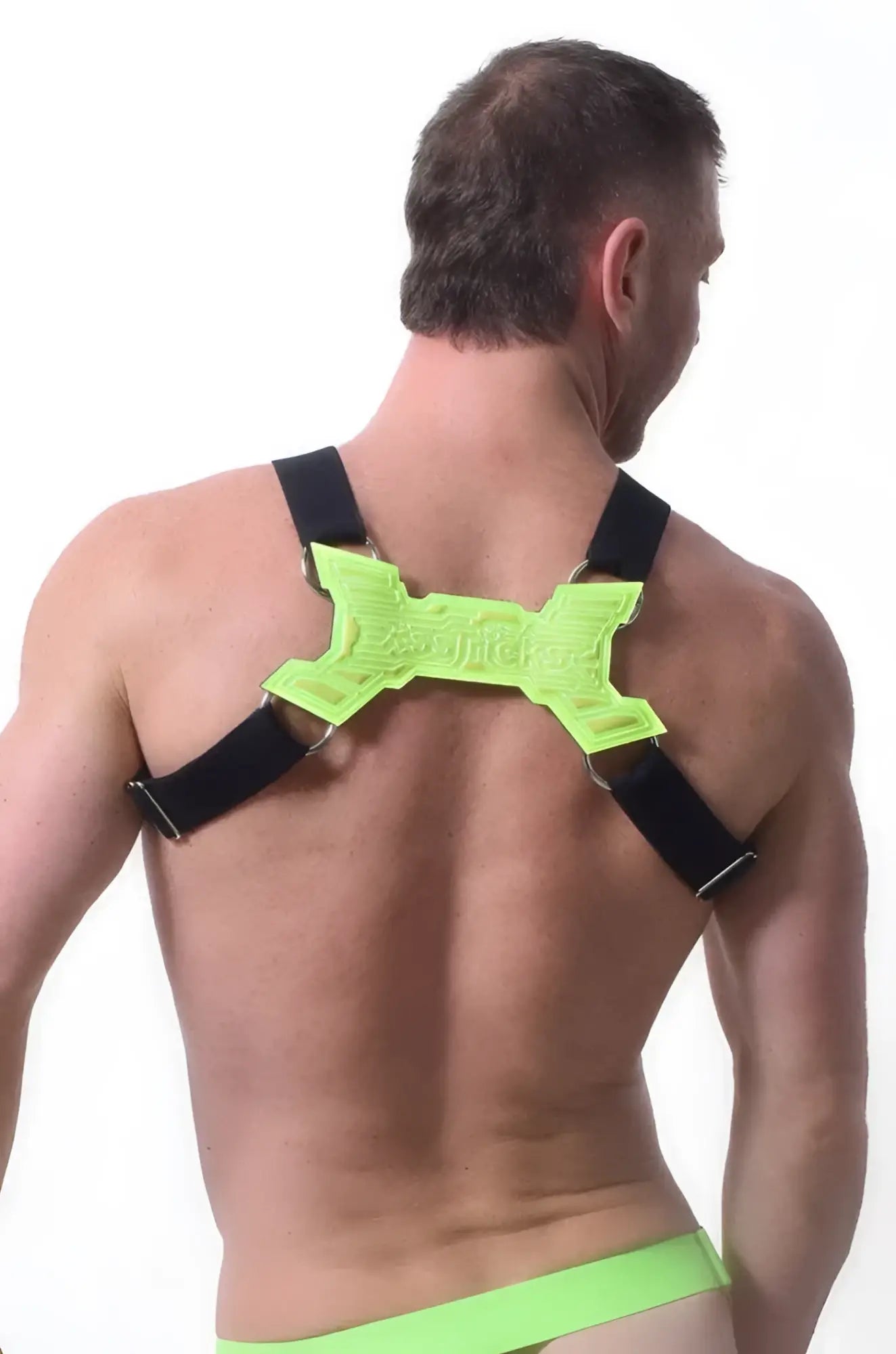 Neon green x-shaped back support with black straps on the back side of transistor harness for ergonomic support