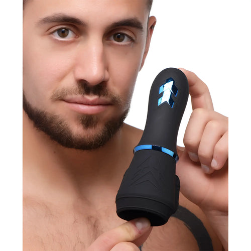Man holding the black, silicone Trinity Men 10X Turbo Penis Head Pleaser with blue metallic accents.