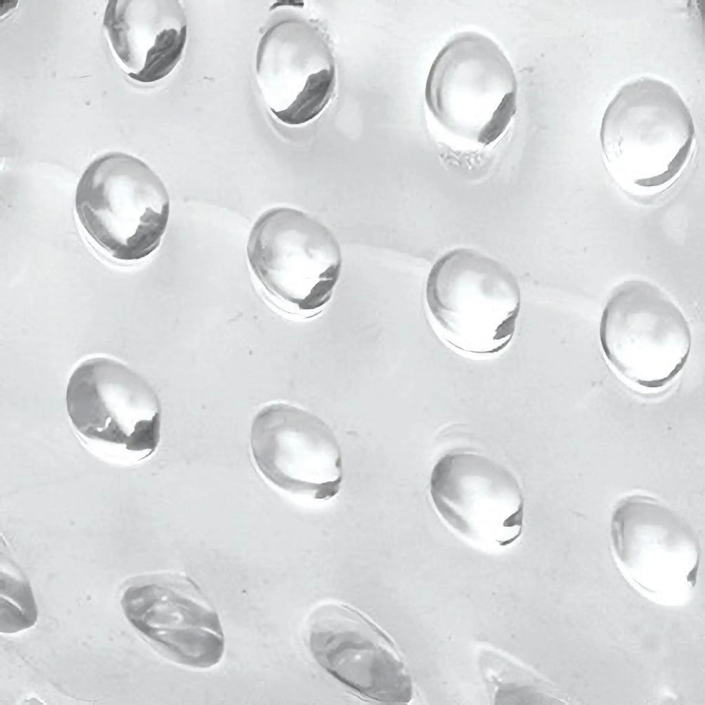 Close-up of the clear, textured surface of a Trinity Men 20X Dual Vibrating Cock Teaser featuring raised bumps.