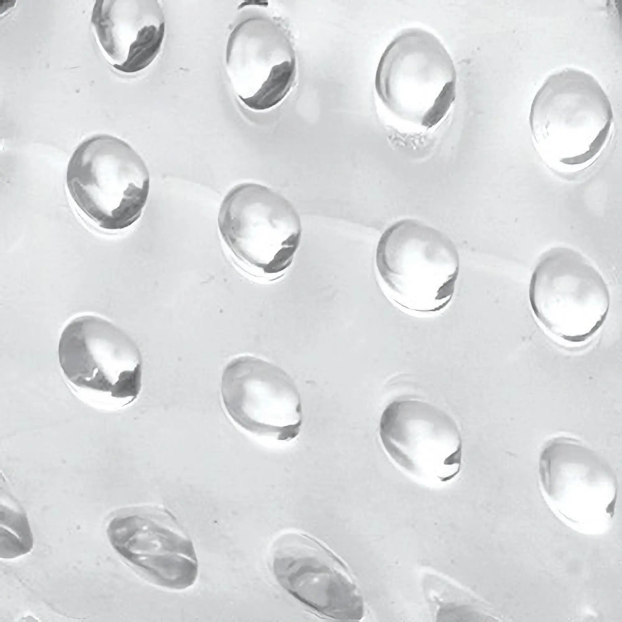 Close-up of the clear, textured surface of a Trinity Men 20X Dual Vibrating Cock Teaser featuring raised bumps.
