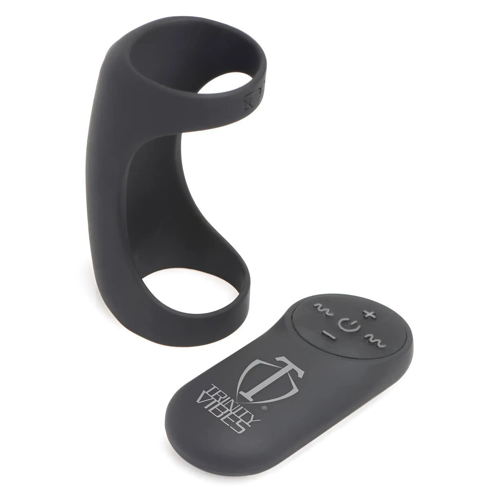 Black Trinity Men 28X G-Shaft silicone ring and matching remote control with power and vibration settings on white.