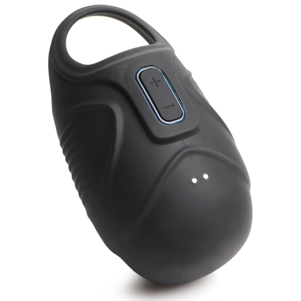 Trinity Men 7x vibrating silicone testicle massager in matte black, featuring a ring top and control buttons.