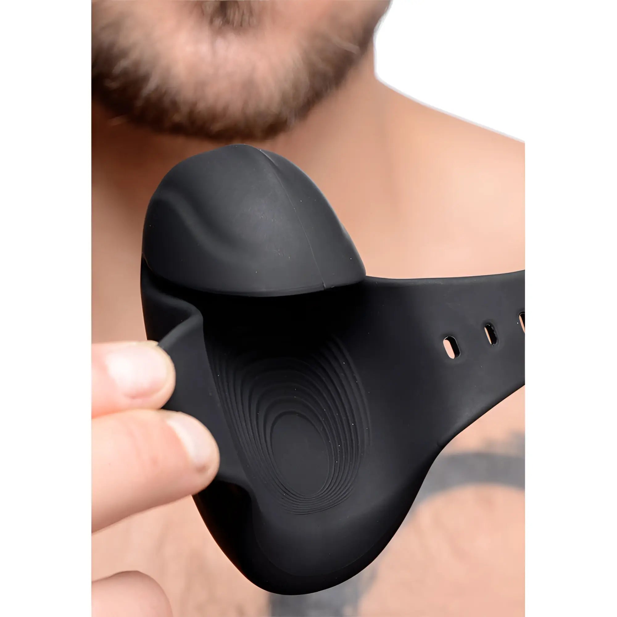 Trinity Men 8X matte black silicone vibrating head stimulator with textured interior and adjustable strap.