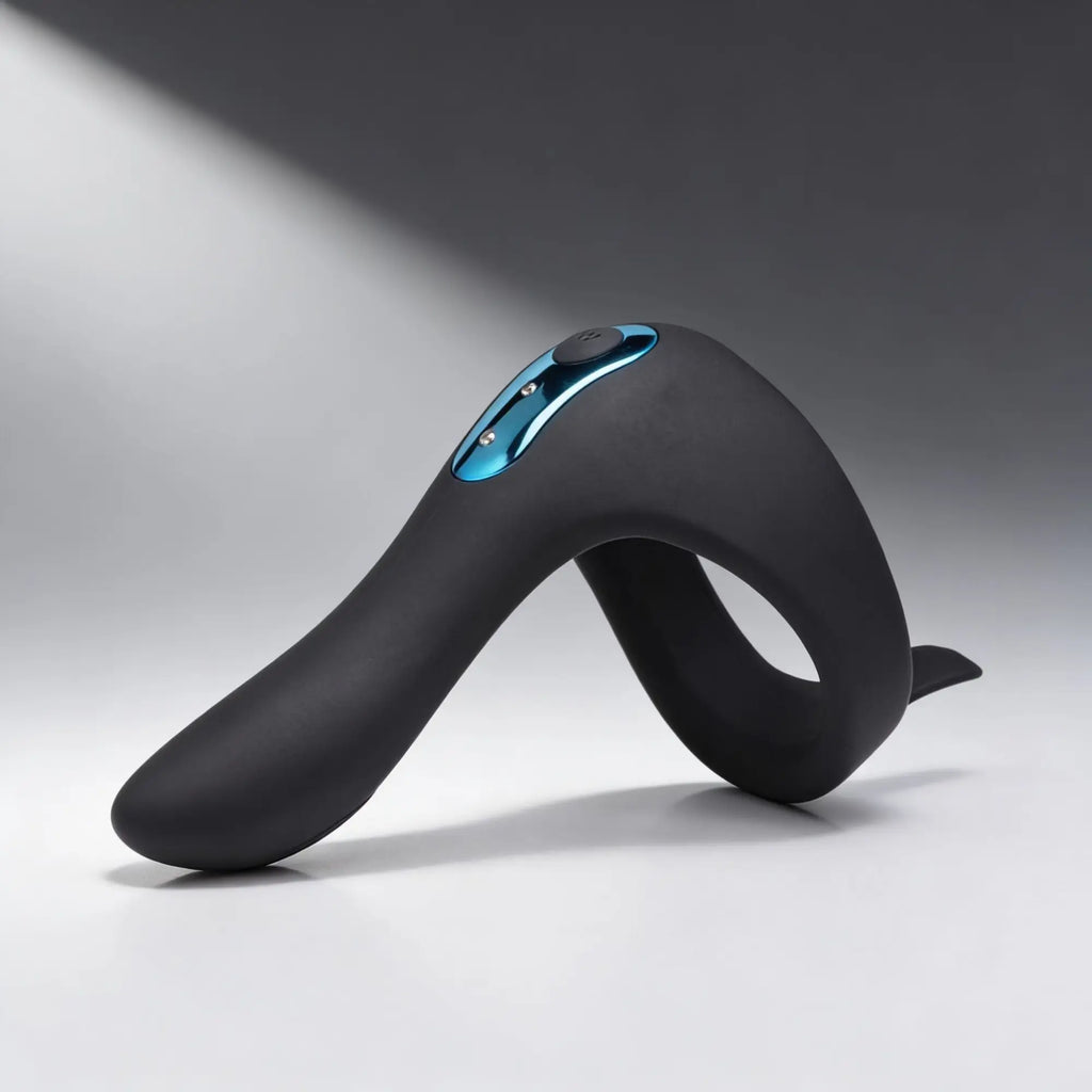 Trinity Men Power Taint 7X: Black matte silicone ring with metallic blue accents against a neutral grey background.