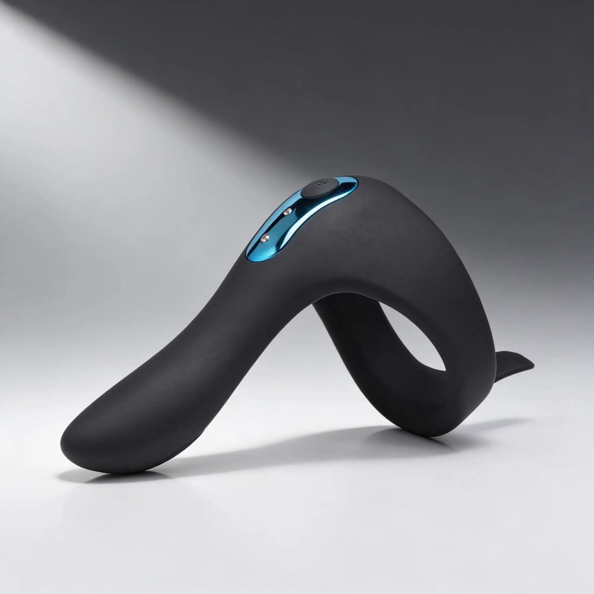 Trinity Men Power Taint 7X: Black matte silicone ring with metallic blue accents against a neutral grey background.