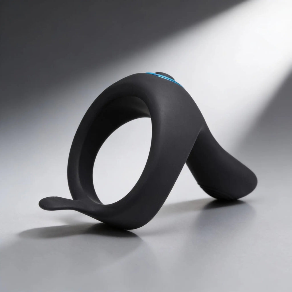 Trinity Men Power Taint 7X: Black silicone cock and ball ring with a pointed stimulator and blue accent.