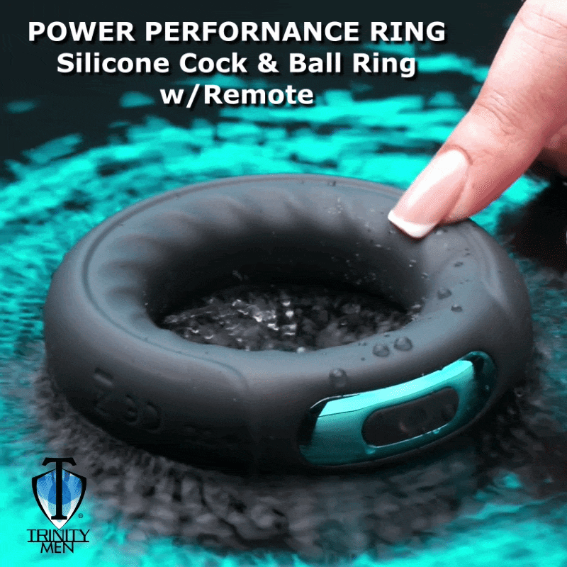 Trinity Men 7X remote-controlled black silicone cock ring with a teal accent, shown on a textured, wavy blue background.