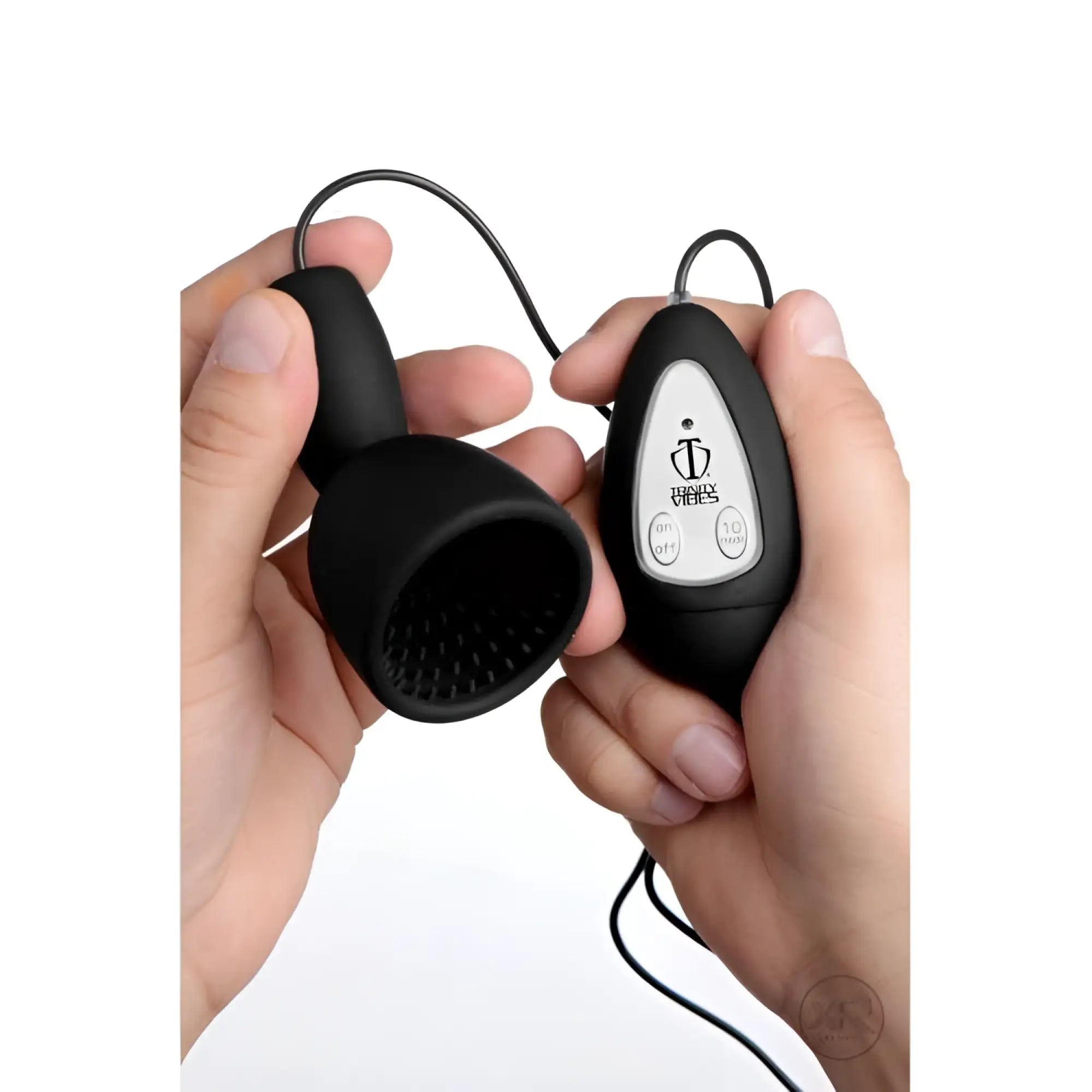 Hands hold a black Trinity Vibes 10-speed silicone teaser with a textured cup and a handheld remote control.