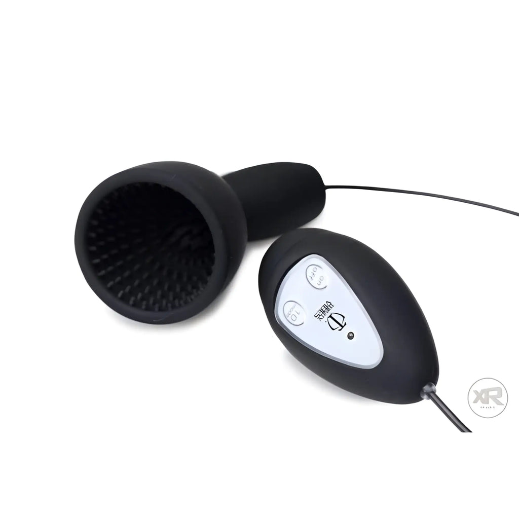 Black Trinity Vibes silicone penis head teaser with a textured interior cup and a wired remote controller.