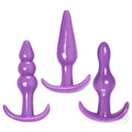 Trinity Vibes 3-piece beginner anal play kit: three smooth, purple silicone butt plugs of various shapes and sizes.