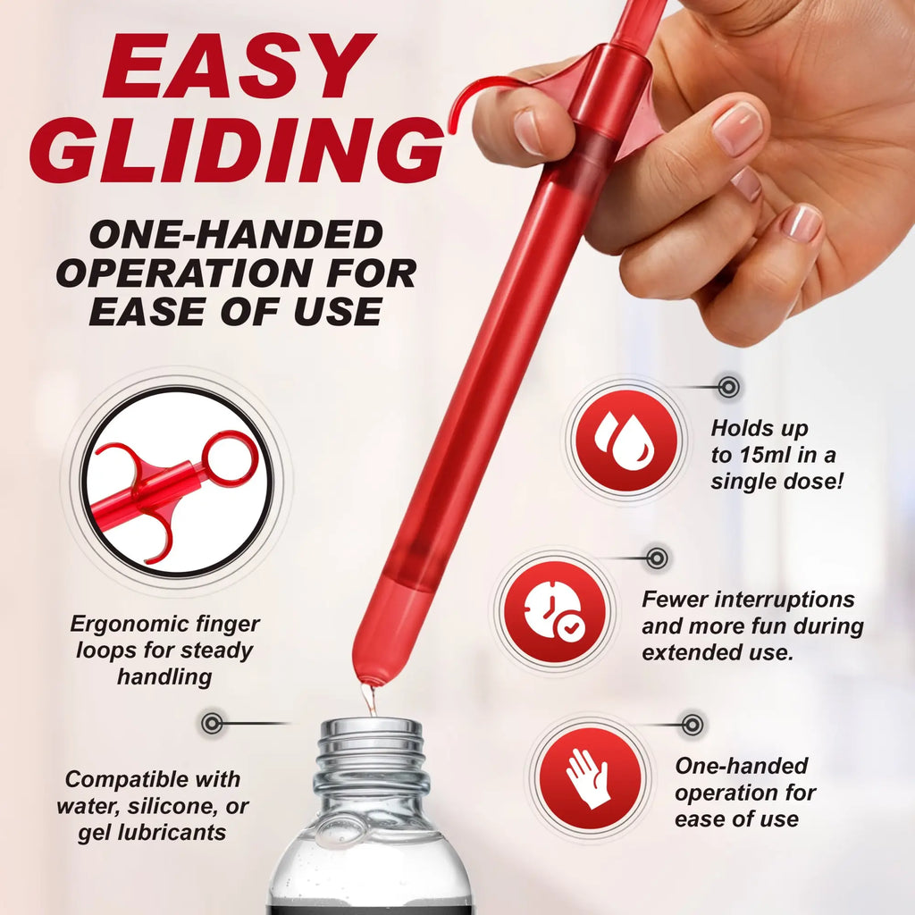 A red Trinity Vibes Lubricant Launcher held in a hand, showing ergonomic finger loops and filling from a bottle.