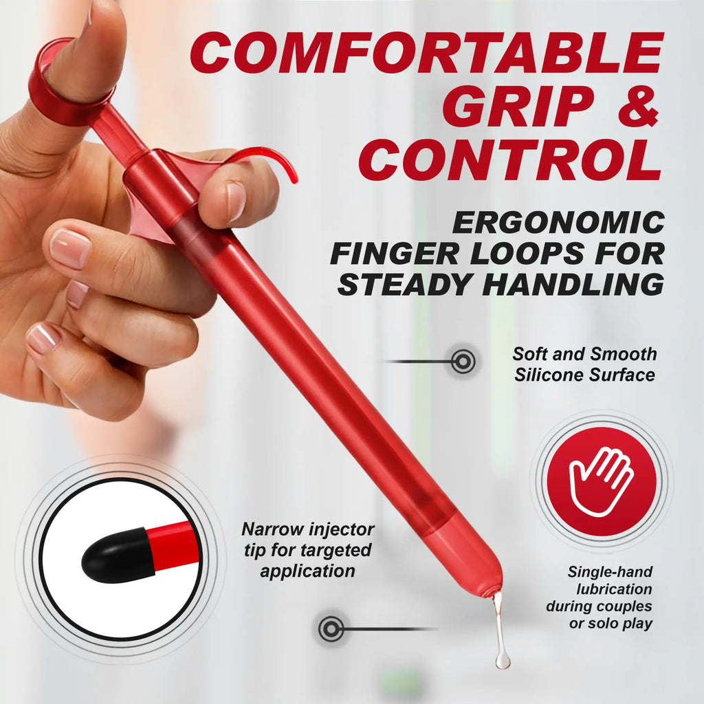 Trinity Vibes Lubricant Launcher: A red, ergonomic manual applicator with finger loops for easy, controlled application.