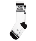 Trophy husband crew socks feature white athletic material with black stripes and text on the cuff with logo near toe