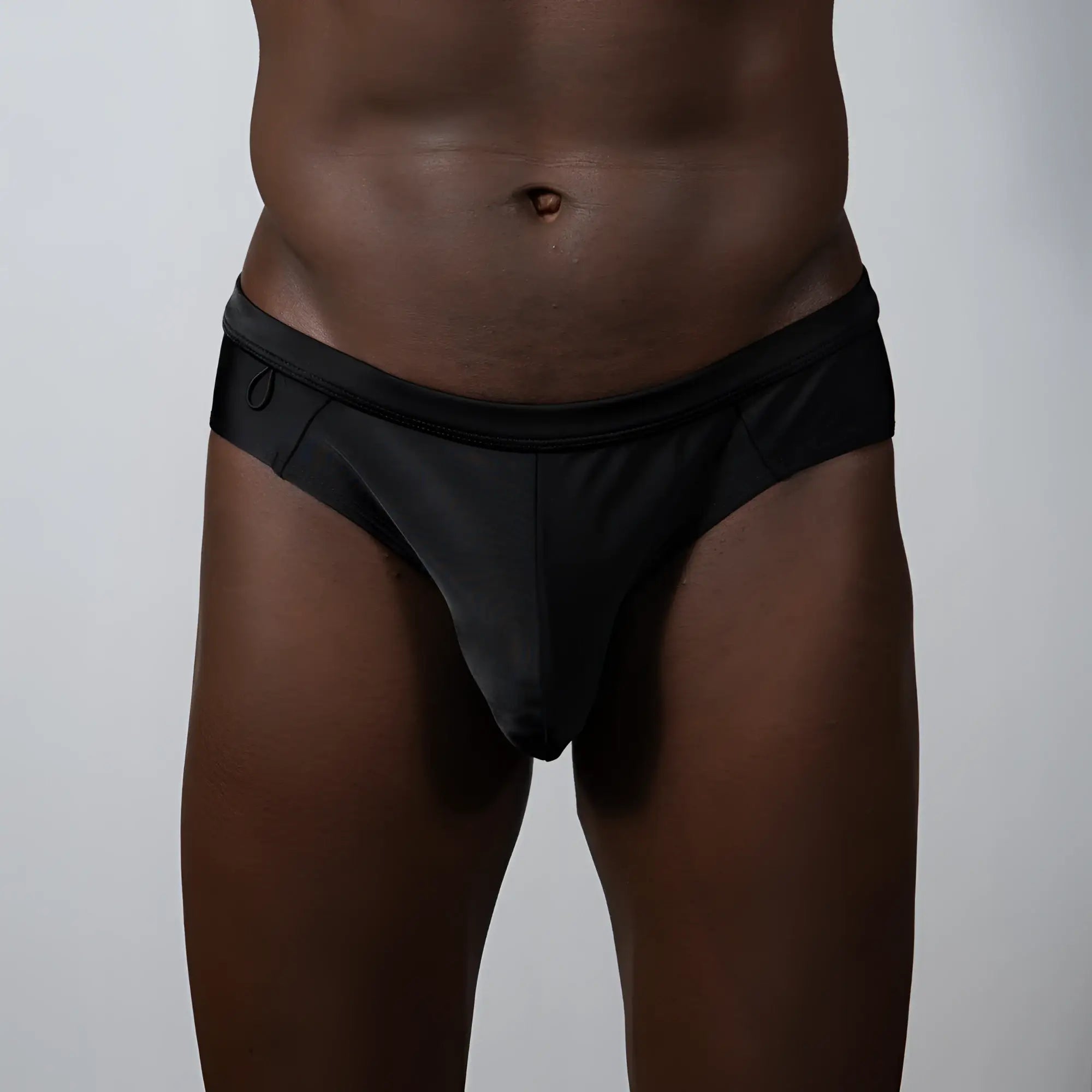 Black sleek form-fitting tulio bikini brief swim trunks with smooth fabric finish for swimming and beachwear