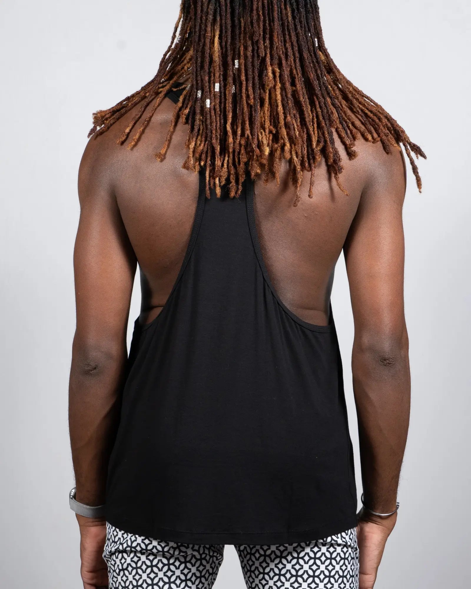 Back view of a black Tulio racerback tank top featuring a cutout design made from breathable material