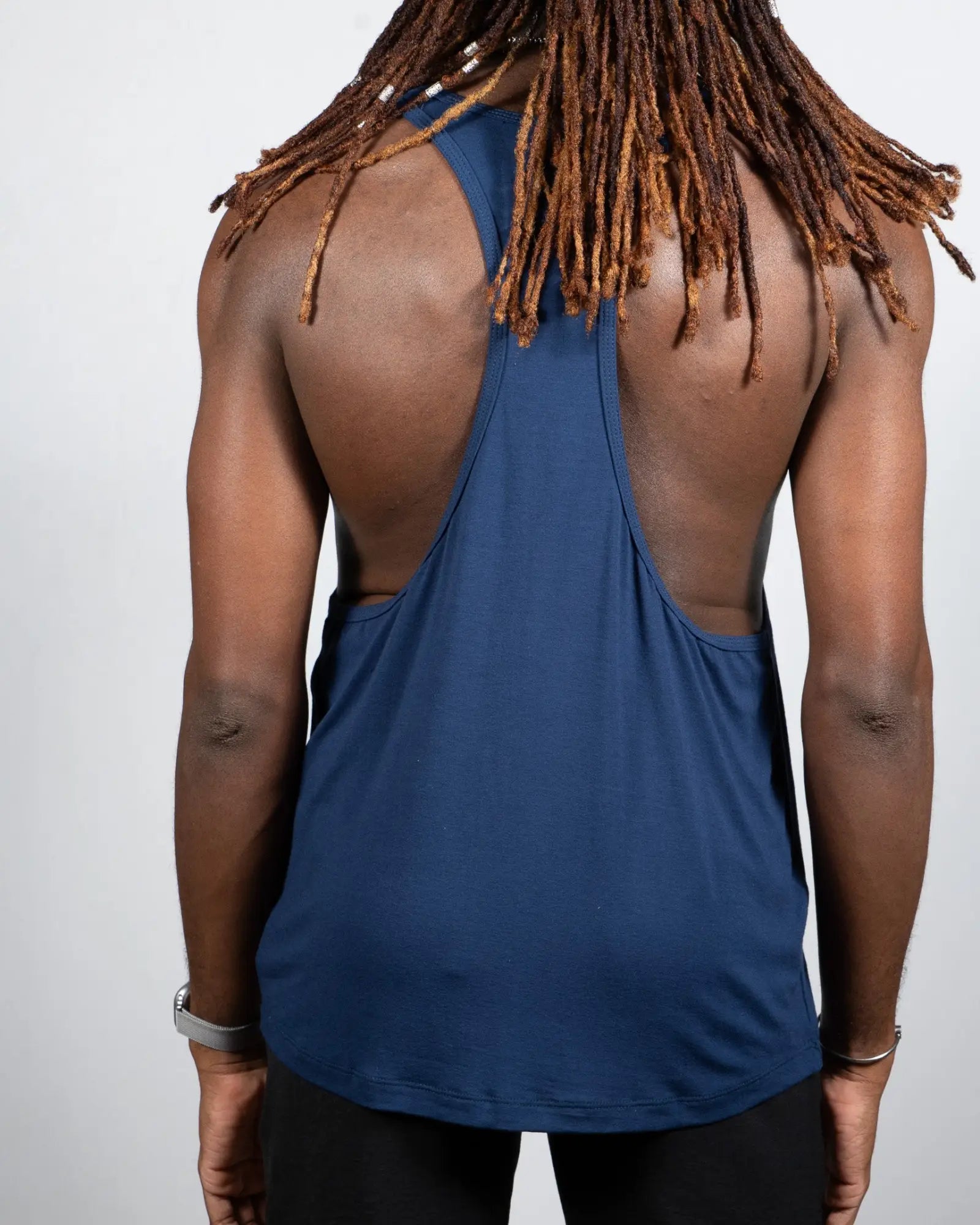 A navy blue Tulio racerback tank top with a cutout back design in breathable fabric for active wear