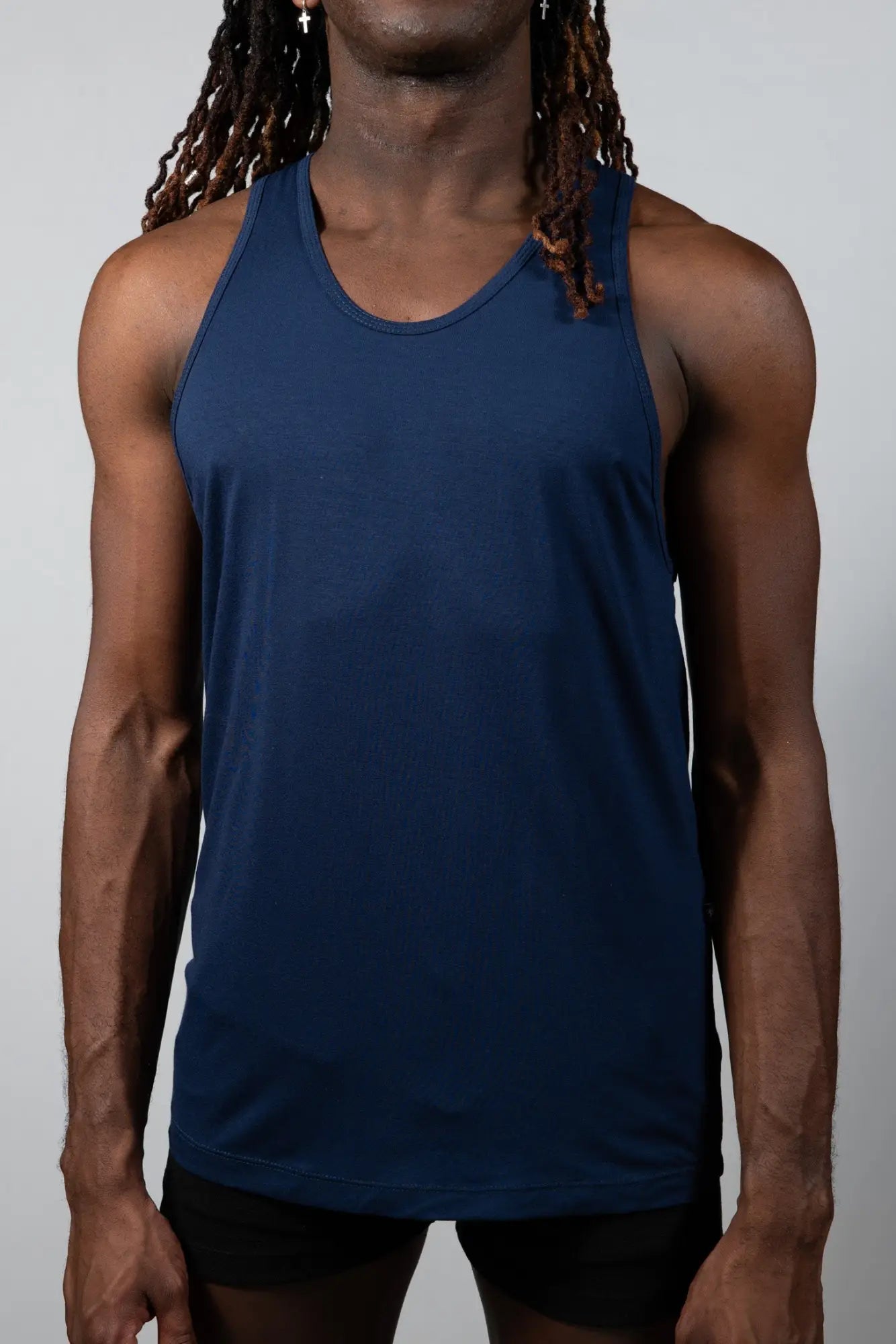Navy blue sleeveless Tulio solid tank with a rounded neckline and smooth stretchy fabric for athletic use