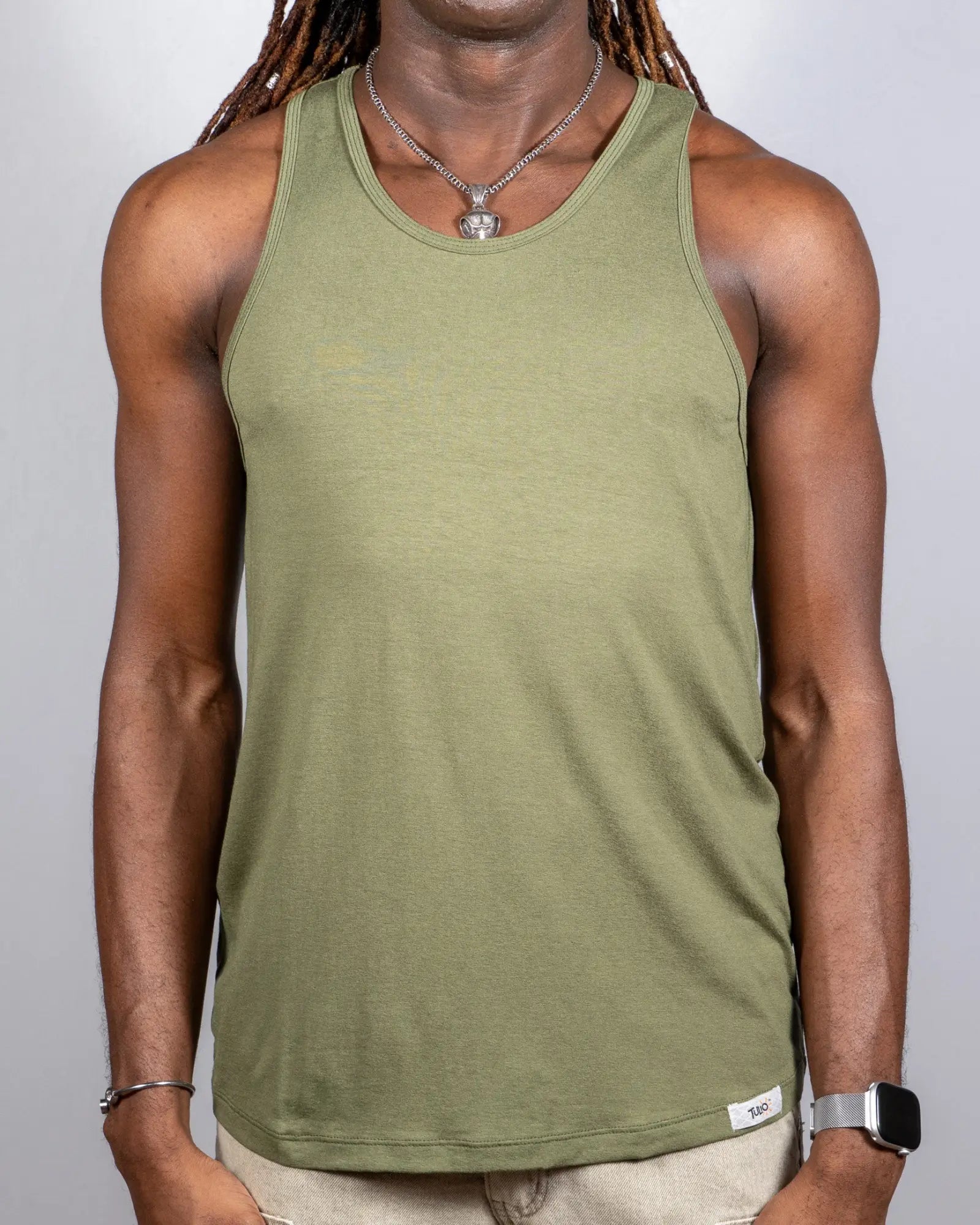 Olive green sleeveless tulio solid tank with ribbed neckline and hem featuring a small white brand tag at bottom right