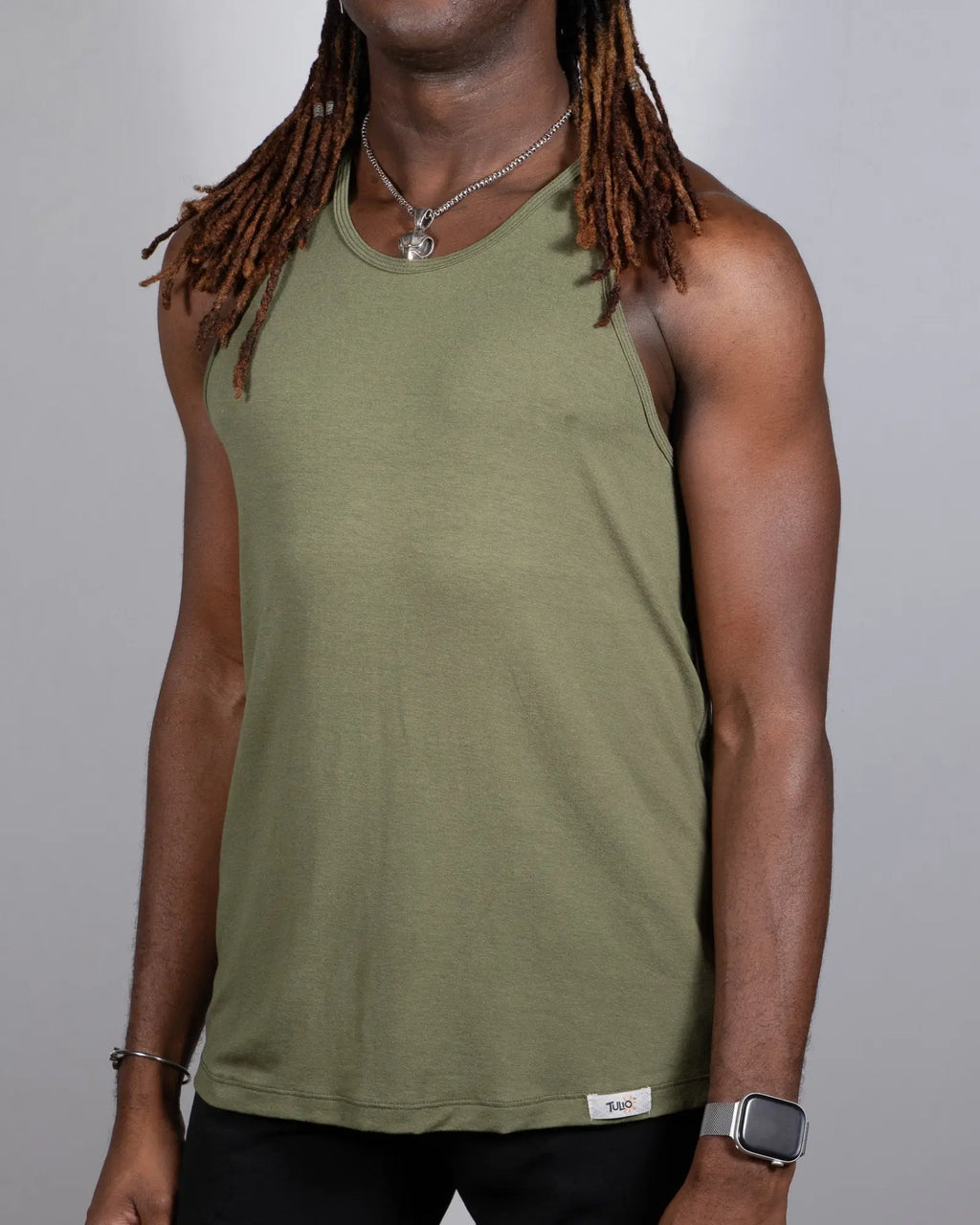 Olive green sleeveless tulio solid tank top with round neckline and small white brand tag at bottom hem