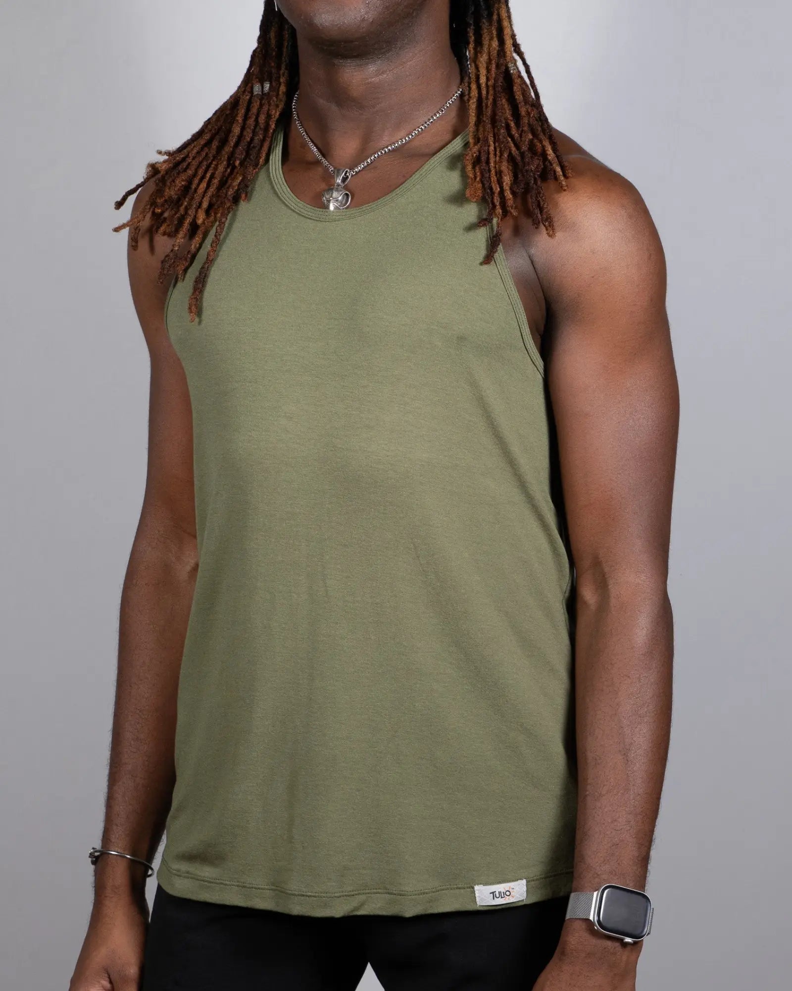 Olive green sleeveless tulio solid tank top with round neckline and small white brand tag at bottom hem