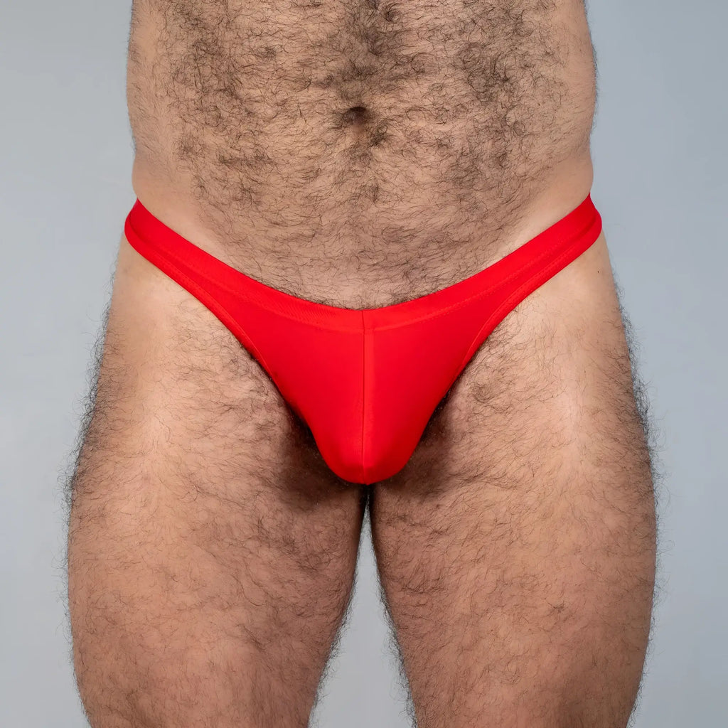 Bright red tulio swim thong made of smooth stretchy fabric with a form fitting design for comfortable swimwear use