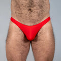 Bright red tulio swim thong made of smooth stretchy fabric with a form fitting design for comfortable swimwear use