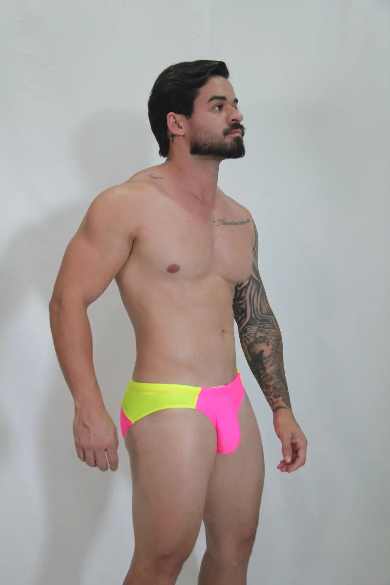 Neon curved swim brief vibrant neon yellow and pink two tone swim trunks with bold modern design front view