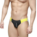 Black and yellow athletic swim trunks with white side panel and ustation brand name in vertical lettering on front