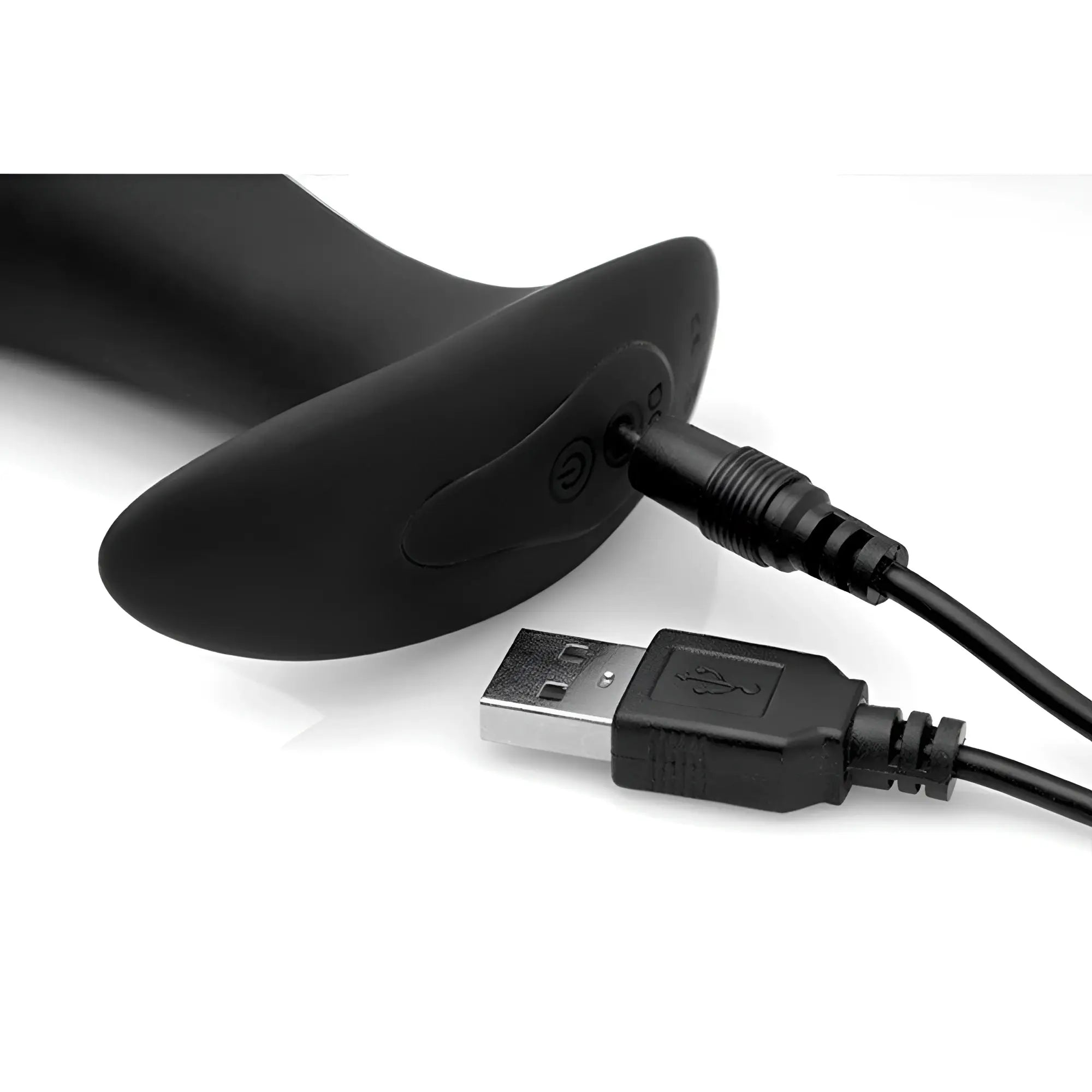 Under Control silicone prostate vibrator shown in matte black with a USB charging cable being plugged into the base.