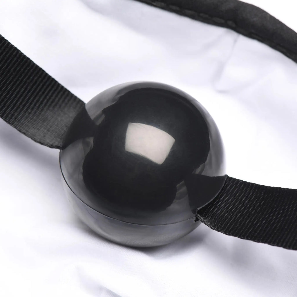 Under Cover ball gag face mask featuring a black glossy spherical gag with black elastic straps for restraint use